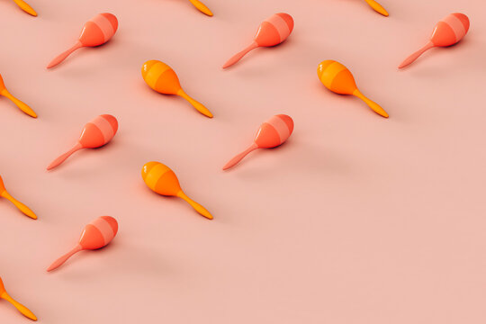collection of colorful maracas on a pink background