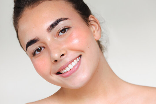 Young woman with her hair up smiling
