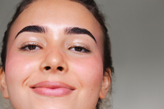 Young woman with her hair up looking at the camera