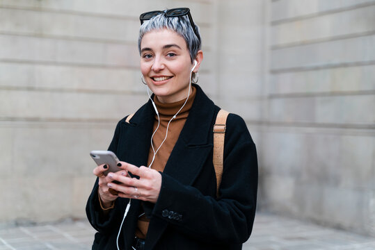 Stylish Woman Listening To Music On Mobile Phone.