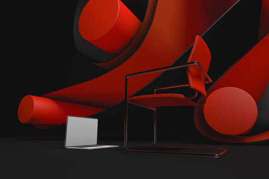 Laptop and chair next to an abstract background