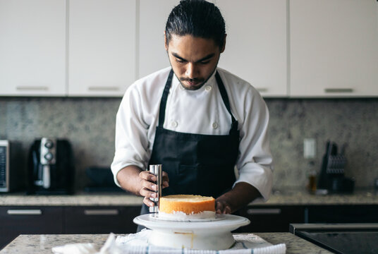pastry chef assembling a cake