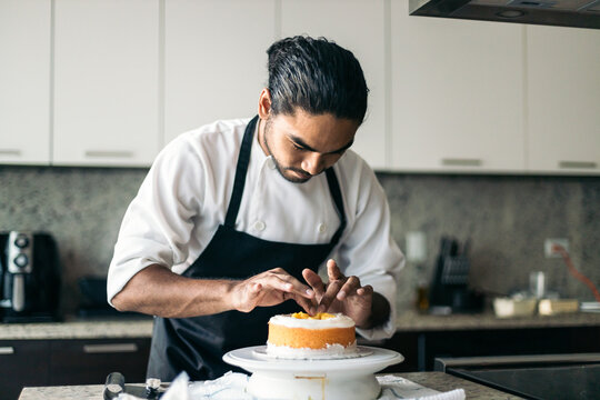 pastry chef assembling a cake