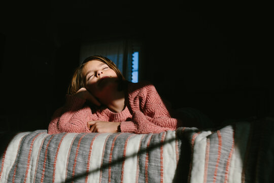 girl turns face into the sun