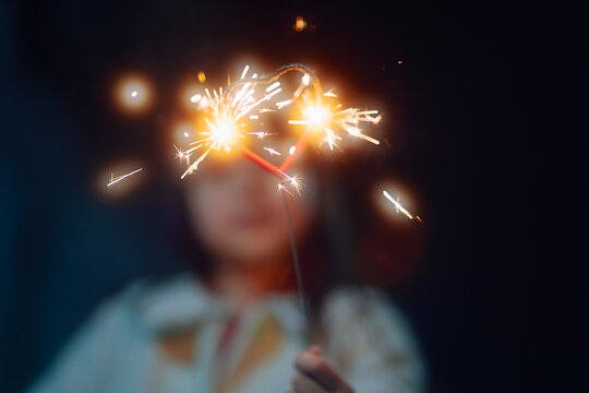 child playing with sparklers 
