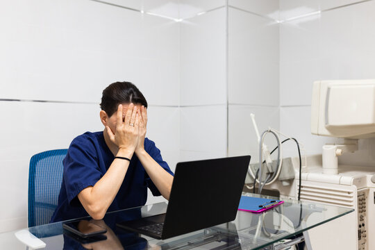 Doctor Using A Computer In The Hospital Office