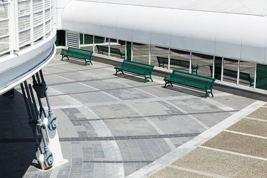 three empty green benches in the courtyard