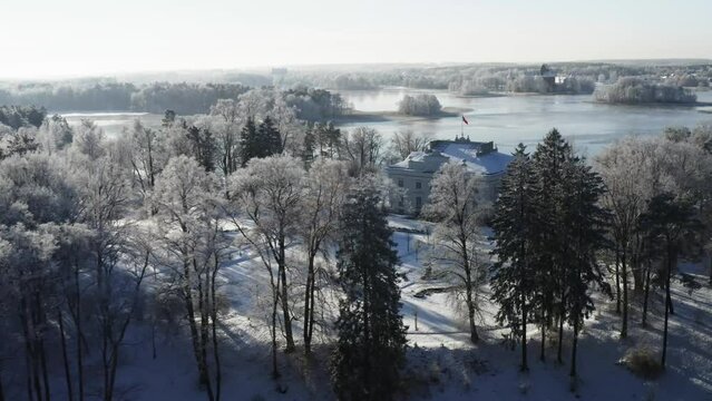 Drone aerial footage of the Trakai Manor in winter time in the middle of the day with sunny weather