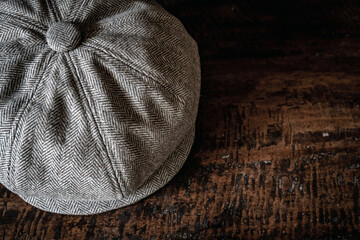 Detail of a classic eight-panel newsboy hat in tweed fabric herringbone in khaki on a classic...