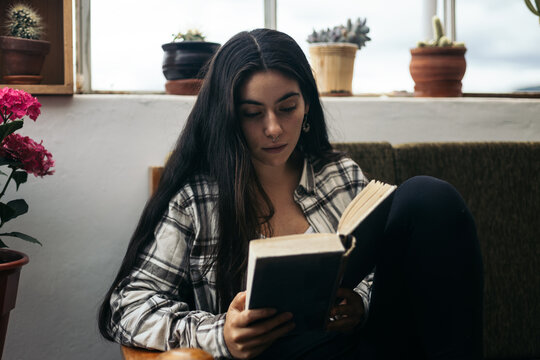 Young woman reading at home