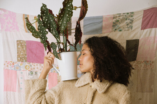 Fashion portrait of a woman with a plant vase