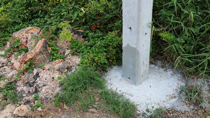 Electric poles and bases. Concrete pillar base for roadside outdoor concrete pillar stability with copy space. Select content and focus