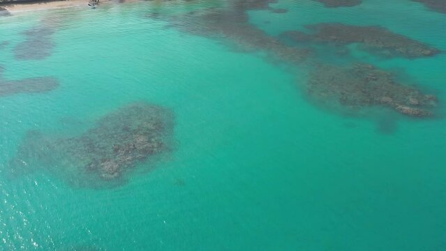 Breathtaking turquoise colored sea water of Playa Punta Popy with motorboat, Las Terrenas in Dominican Republic. Aerial view