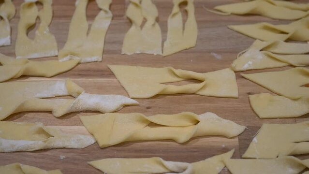Twisted Dough Prepared On The Table For Frying. Making Angel Wings Dish For Fat Thursday Celebration. close up, slider