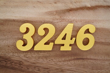 Golden Arabic numerals on a real brown and white wooden floor number 3246