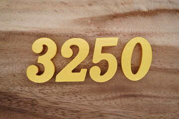 Golden Arabic numerals on a real brown and white wooden floor number 3250