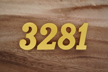 Golden Arabic numerals on a real brown and white wooden floor number 3281
