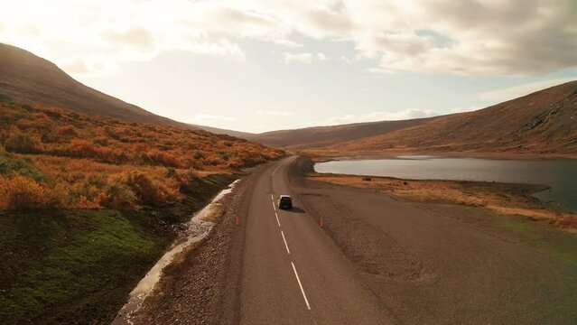 Scenic View Of Car Driving On Oxi Mountain Road During Sunset In East Iceland. Aerial Drone Shot