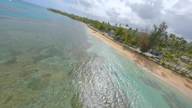 Extreme racing drone flight over playa Punta Popy at Las Terrenas in Dominican Republic. Aerial forward