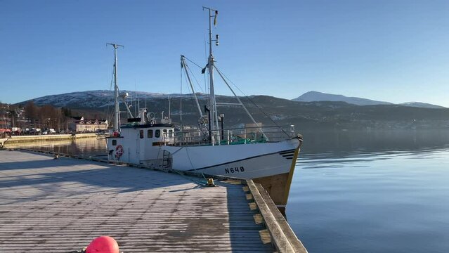 Left to right view of a Norwegian fishing boat in Fauske, Skjerstad Fjord, Nordland, Northern Norway 4k.