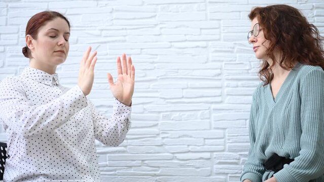 The psychotherapist conducts a hypnosis session. Female patient under hypnosis.