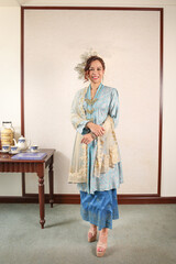 Beautiful young woman wearing Mahsuri style Baju Kebaya Labuh traditional malay Malaysian dress fashion
