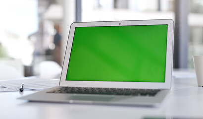 Make sure your landing page makes the loudest statement. Shot of a laptop with a green screen on a desk in a modern office.