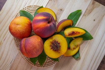 Yellow Peach with slice on wooden background. Fresh Yellow Peach.