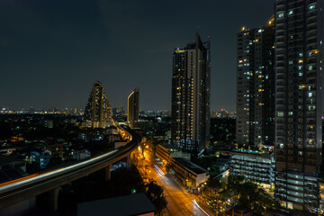 Fototapeta na wymiar aerial view of Towers business area on night Business District Low Light, Over Urban Junction concept or abstract of advanced innovation, financial technology, energy power 