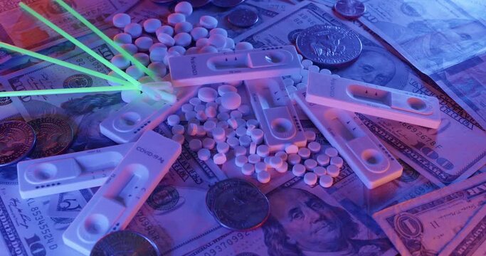 Covid Test Kit with glowing probes on top of medicine and US Dollar banknotes