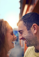 Laugh often, love always. Shot of a happy young couple sharing an affectionate moment while exploring a foreign city.