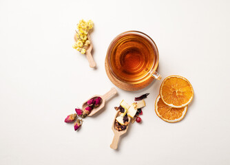 A cup of herbal tea with dried flowers, fruits and berries. The concept of healthy eating. Top view and copy space