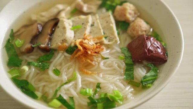 Vietnamese Rice Noodles Soup with Vietnamese Sausage served vegetables and crispy onion - Asian food style
