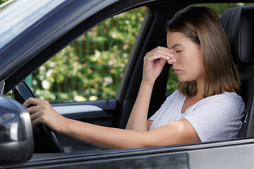 Obraz na płótnie Canvas closeup shot of stressed young woman driver in a car