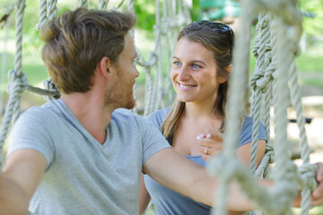 two person climbing a tree in an adventure park