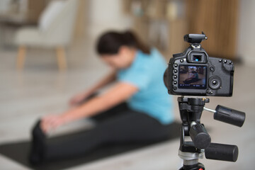 woman recording her fitness routine on camera