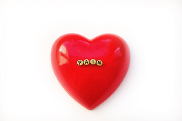 Headline Pain on red heart, white background