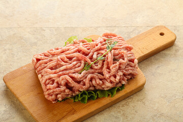 Raw minced pork meat over board