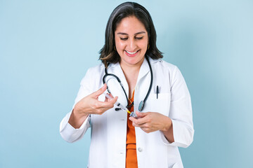 latin woman doctor holding vaccine injection in Mexico latin America	
