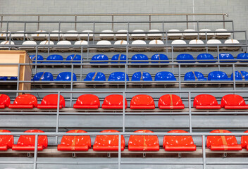 Red and blue seats on the stadium tribune.