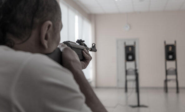 A man shoots from a gun at a target.