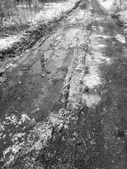 Frozen puddles on a dirt road. Nature in winter