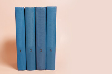 A stack of books on a colored background. Space for text