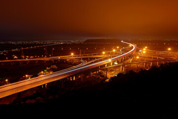Fototapeta premium Aerial view of transporting structures with highway and interchange at night, Taichung Taiwan 