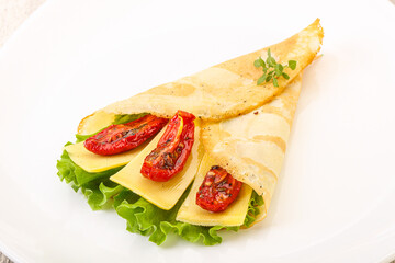 Pancake with cheese and dry tomato