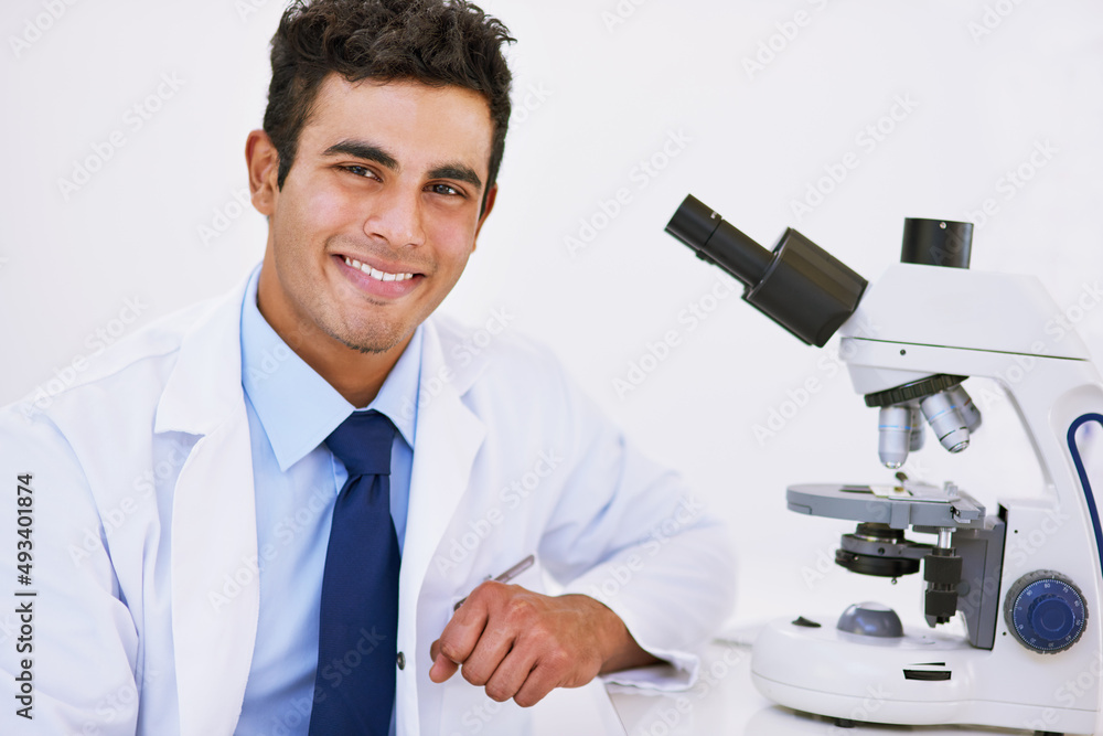 Canvas Prints Finding solutions in the small things. Portrait of a smiling lab technician using a microscope while sitting in a lab.