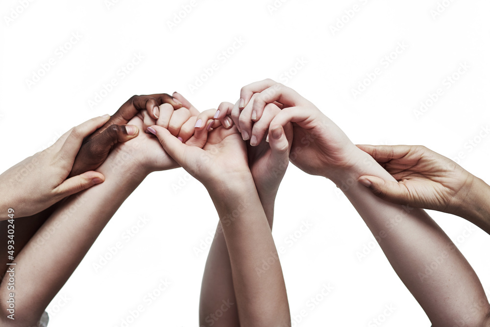 Poster Embracing unity through diversity. Shot of a group of hands holding on to each other against a white background.