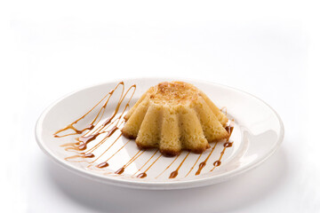 pastel de elote con cajeta, corn pie with burnt milk on a plate on white background