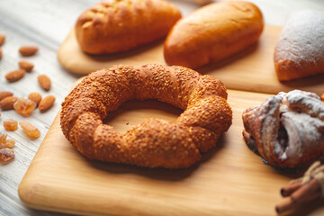 Various freshly baked sweet buns on wooden background