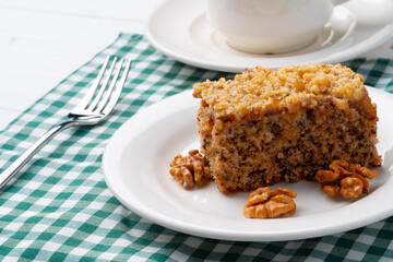 Piece of nut cake on white plate